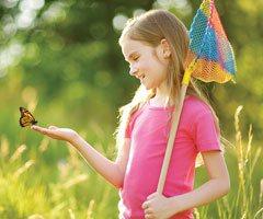 Little girl catching butterflies